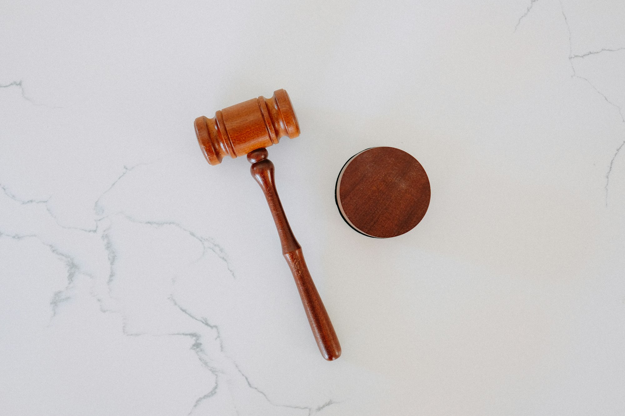 A wooden gavel on a marble surface